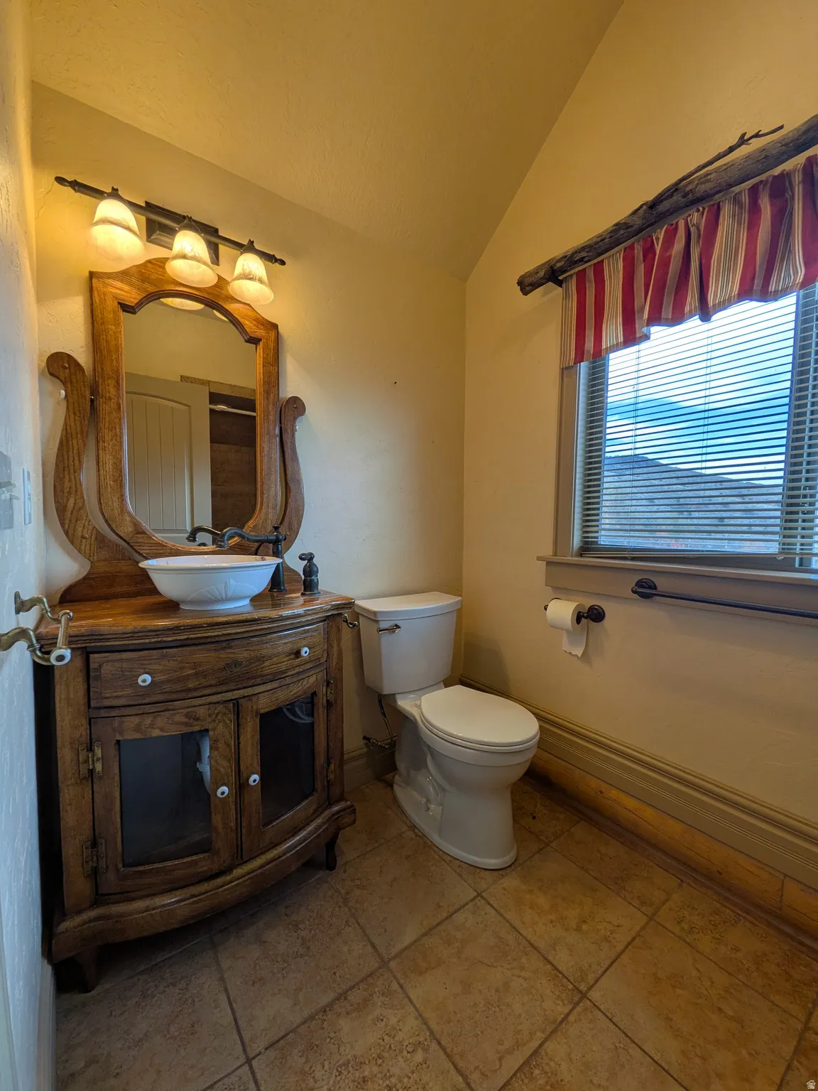 Wood-finish vanity with an integrated basin sink and a decorative mirror