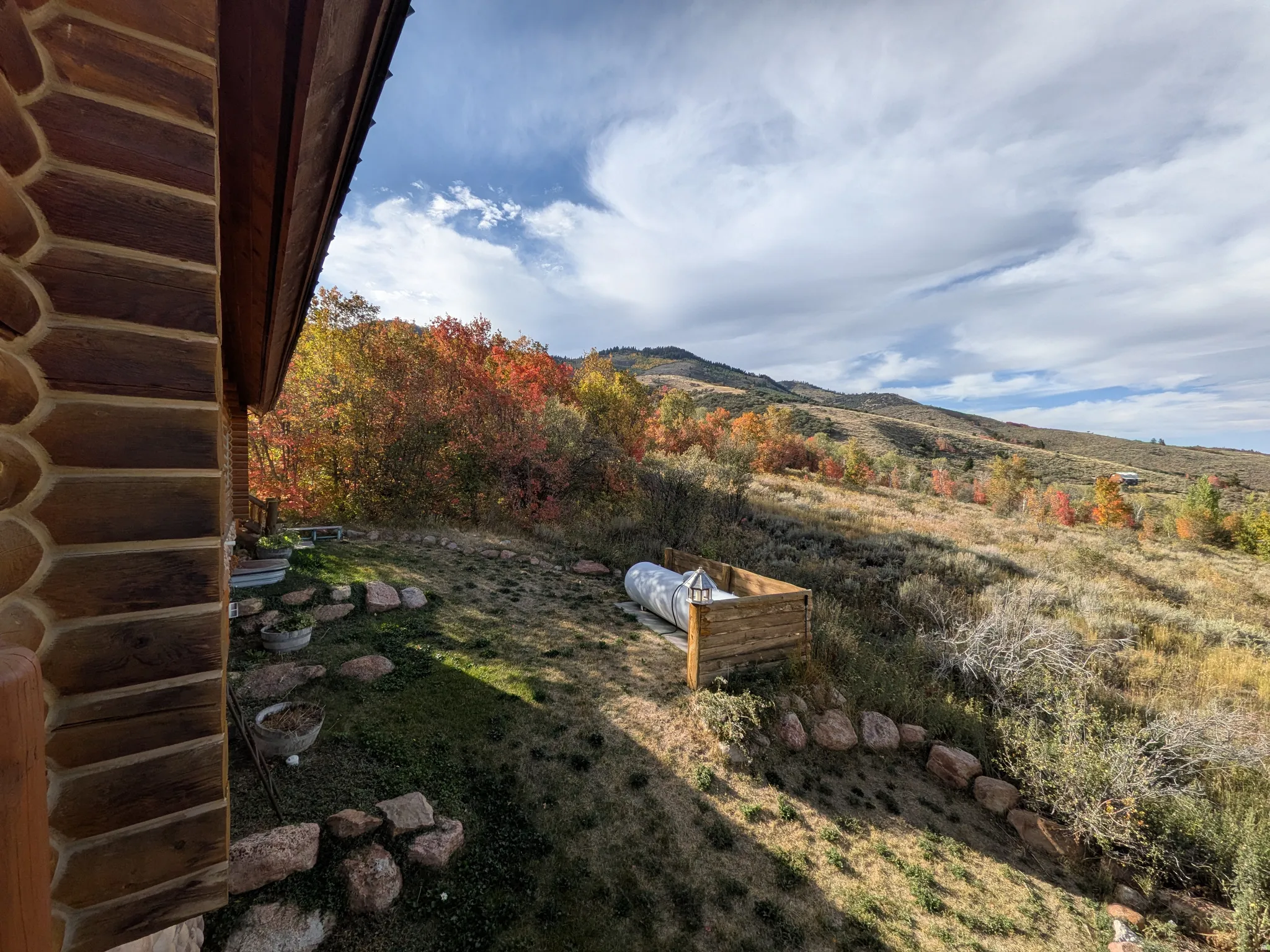 Log exterior construction north side of home with moutain views and some lake views. Propane tank etc.