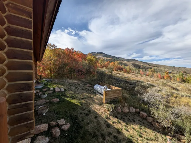 Log exterior construction north side of home with moutain views and some lake views. Propane tank etc.