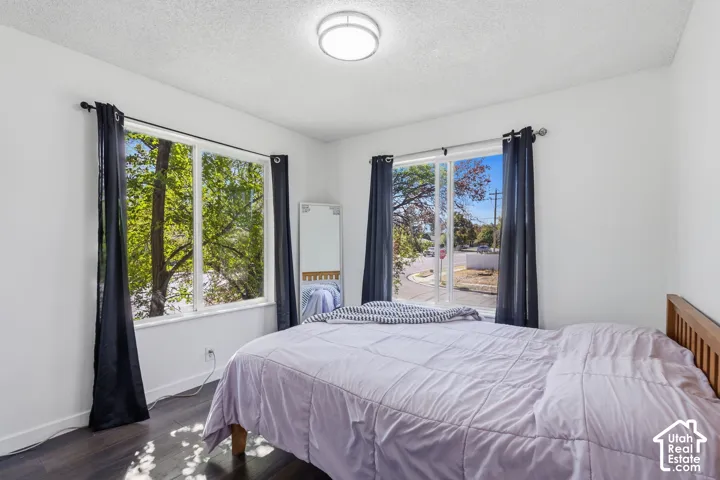 Bright interior with dark wood-finish flooring, white walls, and an overhead flush-mount light fixture