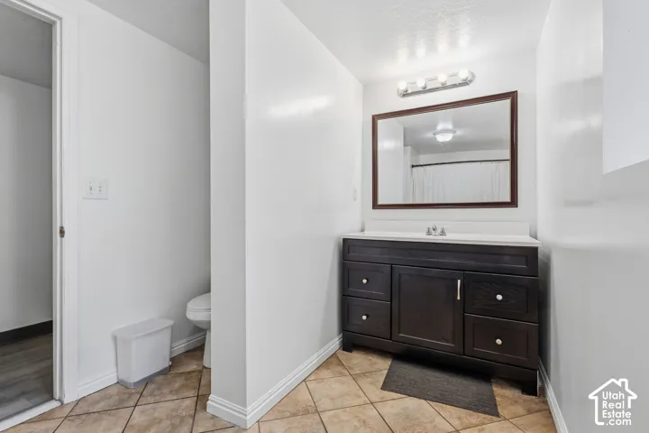 Dark wood-finish vanity with white countertop and integrated sink