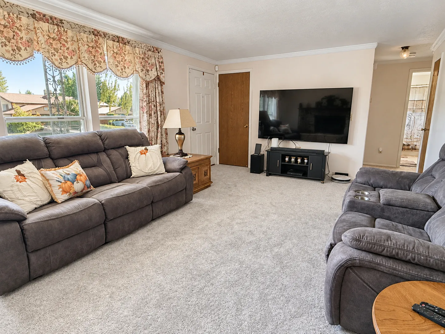 Light-colored carpeting throughout, white painted walls, and white trim