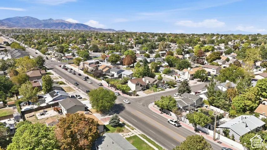 Residential area with established trees and mountain backdrop