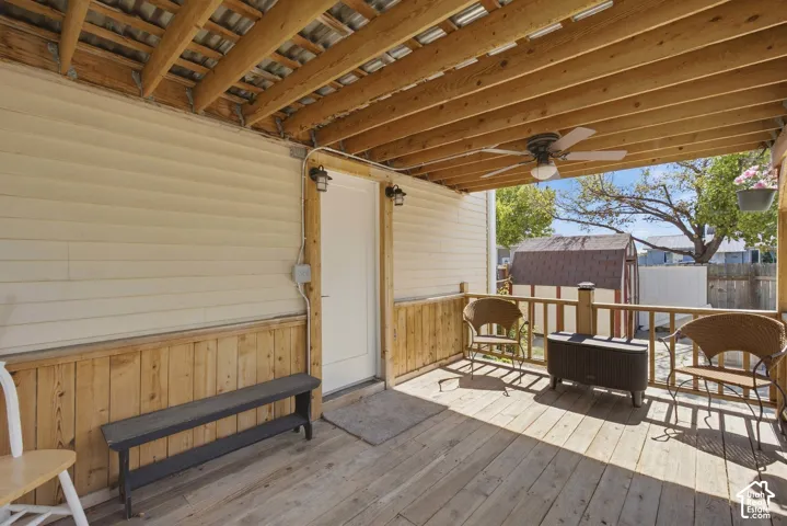 Covered porch featuring wood decking and a wood-finish railing