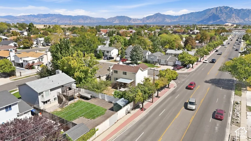Residential property featuring a fenced backyard, an upper-level wood deck, and a lower-level patio