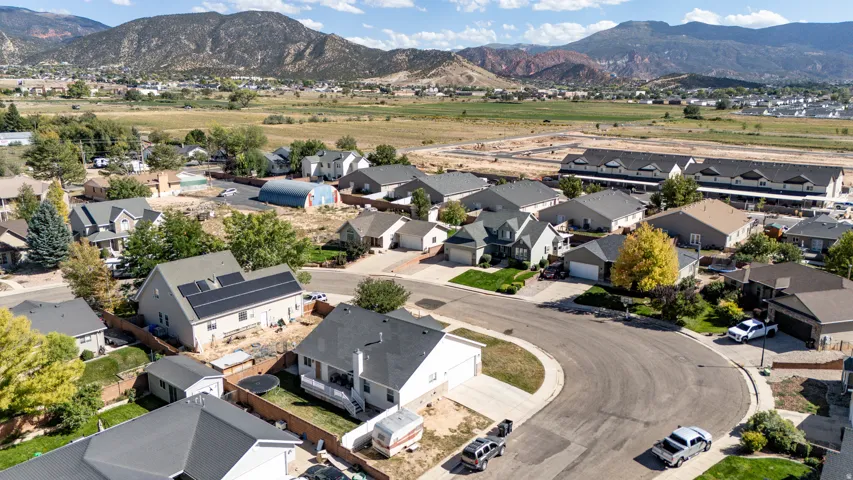Residential neighborhood with mountain backdrop and mature landscaping