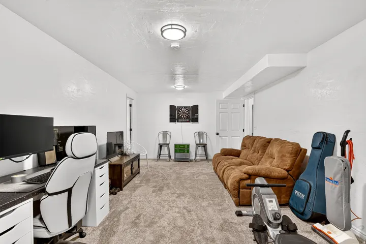 Carpeted flooring, recessed lighting, and a built-in ceiling soffit
