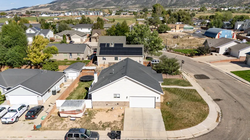 Single-story residence with an attached garage and a partially fenced yard