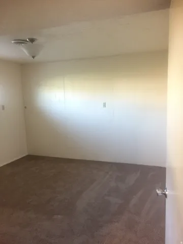 Basement bedroom (west side) Wall-to-wall carpeting and white painted walls. Photo shown was taken prior to tenant occupancy and is provided for reference.