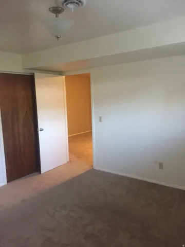 Basement bedroom (north-west) looking towards living area. Photo shown was taken prior to tenant occupancy and is provided for reference.