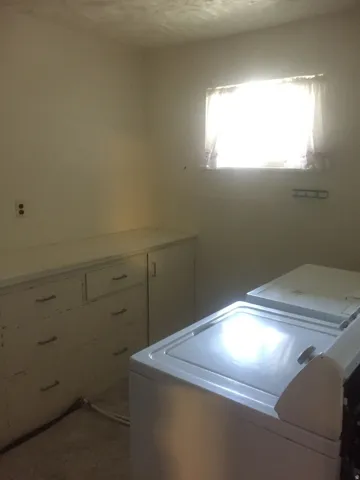 Built-in cabinetry with drawer storage was removed during laundry upgrade- Photo shown was taken prior to tenant occupancy and is provided for reference.