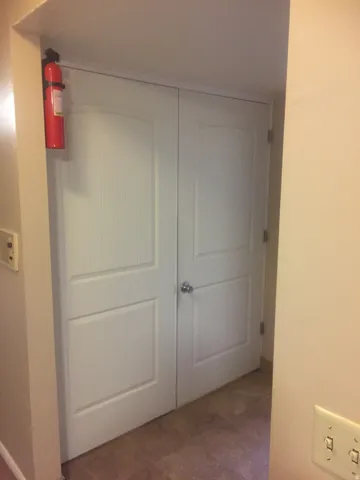 Double doors to spacious laundry area. Photo shown was taken prior to tenant occupancy and is provided for reference.