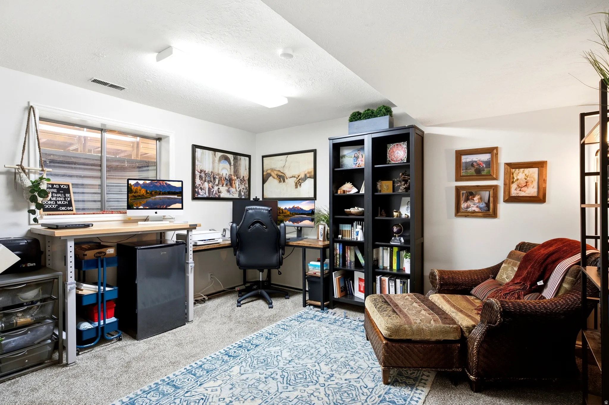 Recessed window with exterior grates, built-in shelving unit, and carpeted flooring