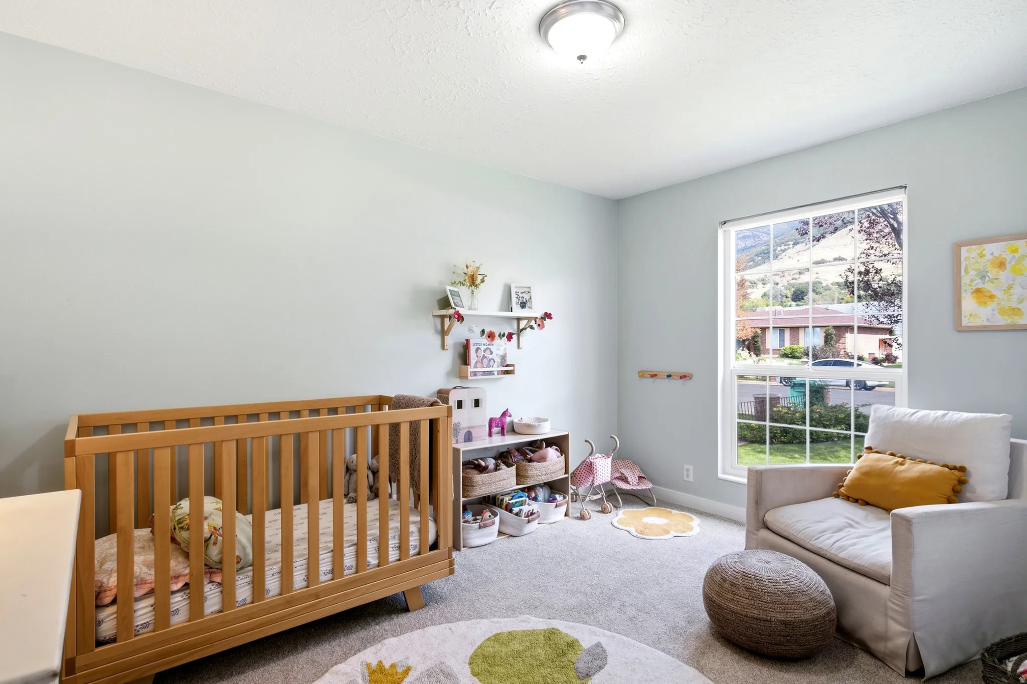 Softly painted walls, textured carpeting, a large window, and recessed lighting