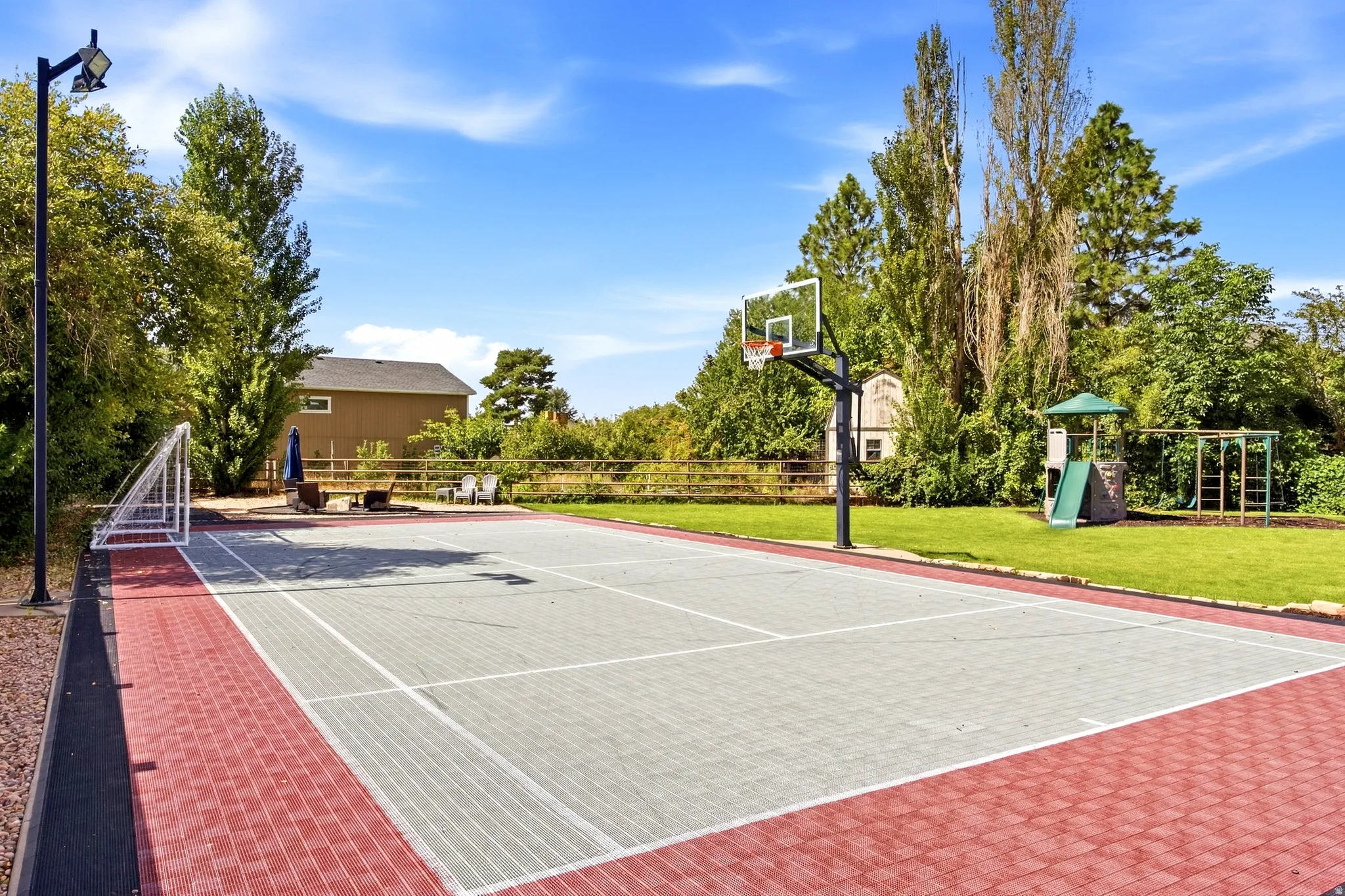 Multi-sport court with a basketball hoop and soccer goal