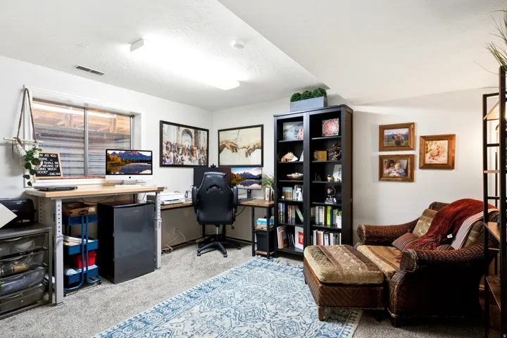 Recessed window with exterior grates, built-in shelving unit, and carpeted flooring