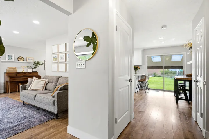 Wood-finish flooring throughout, recessed lighting, and a sliding glass door with skylights