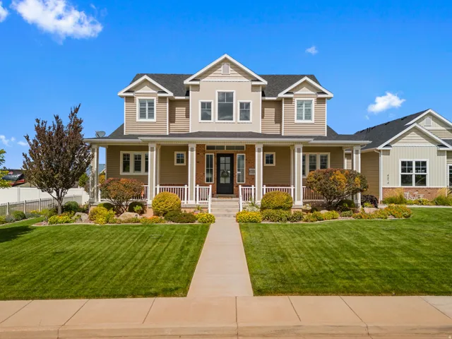 Two-story exterior with a covered porch, gabled rooflines, and a concrete pathway leading to the entrance