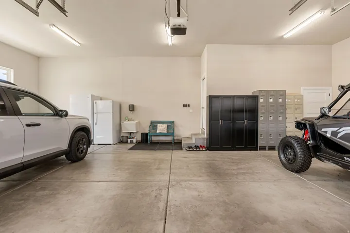 Concrete flooring, overhead lighting, and white walls