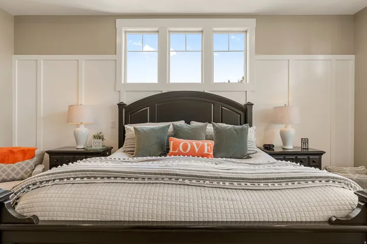 Board and batten accent wall, transom windows, and dual built-in nightstands