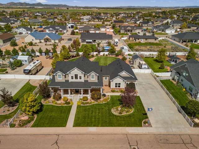 Multi-level residence featuring a covered front porch, gabled rooflines, and a well-maintained front lawn