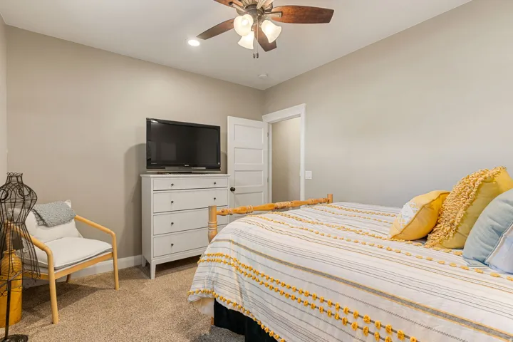 Recessed ceiling lighting, ceiling fan with light fixture, neutral wall paint, and soft carpet flooring