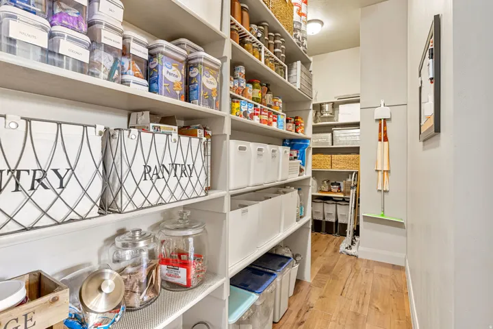 Built-in shelving for extensive storage, wood-finish flooring, and recessed lighting