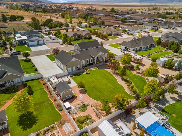 Expansive property featuring a spacious residential structure, detached garage, and a substantial paved driveway