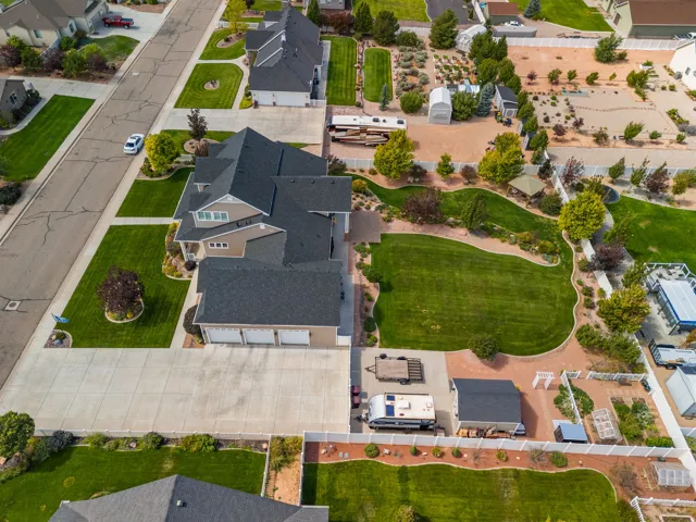 Spacious property featuring expansive lawns, mature landscaping, and a substantial driveway