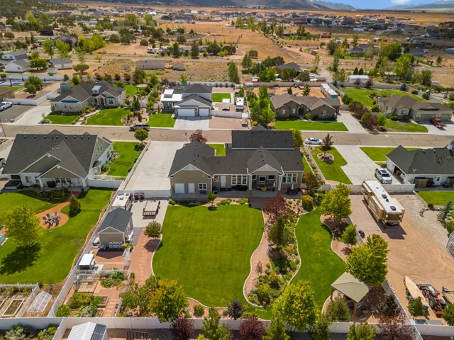 Spacious property featuring a large manicured lawn, established landscaping, and a well-defined paved driveway