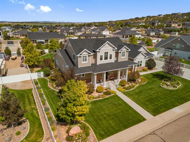 Two-story residence with a covered front porch, dormer windows, and a multi-gabled roof