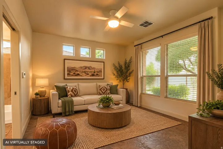 Expansive room featuring multiple windows, a ceiling fan, and rich flooring