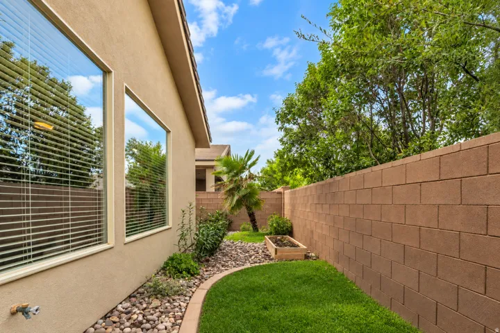 Manicured lawn with a stone-lined garden bed