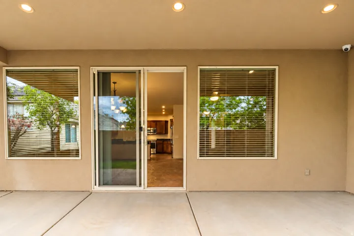 Covered patio with recessed lighting, concrete flooring, and sliding glass door entry to the interior