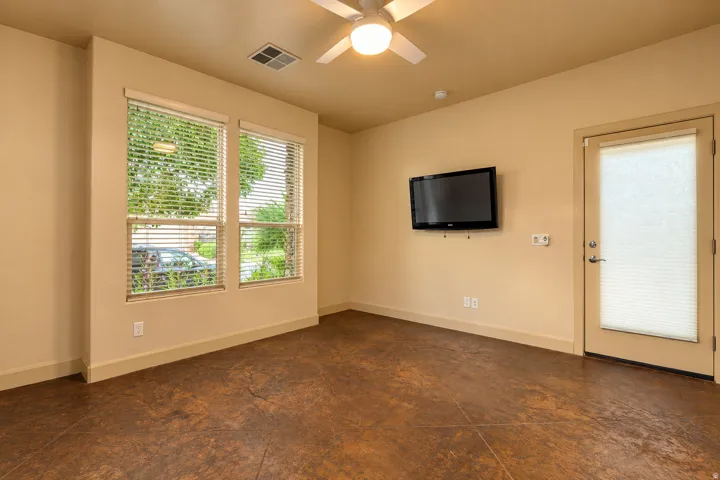 Neutral wall tones complement the durable concrete flooring