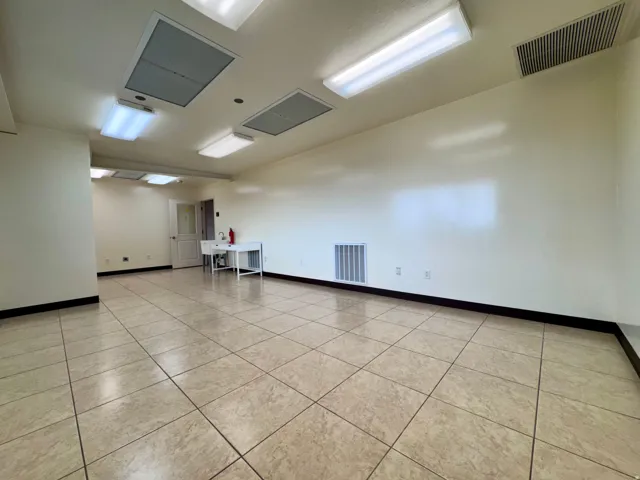 Unit A- Tile flooring, recessed lighting, and wall-mounted air conditioning vents