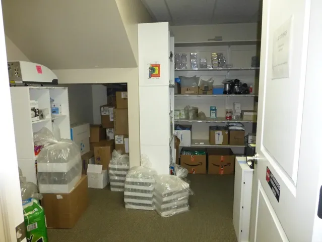 Unit D- Integrated shelving units, carpeted flooring, and a white paneled door