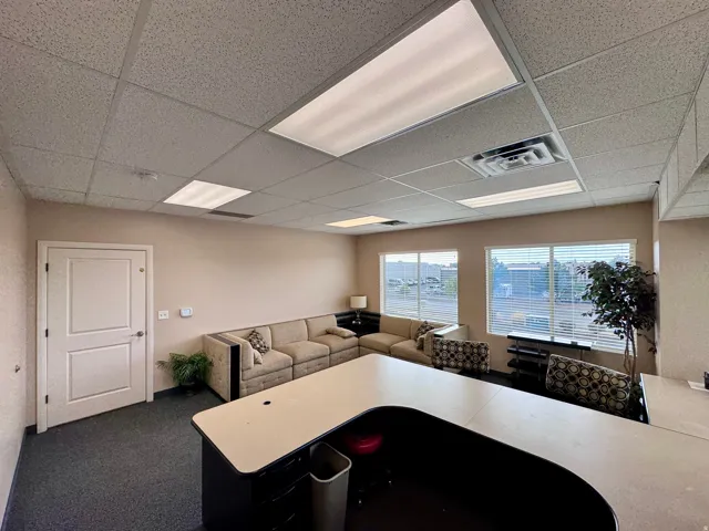 Unit A- Recessed lighting, drop ceiling, and multiple windows with horizontal blinds