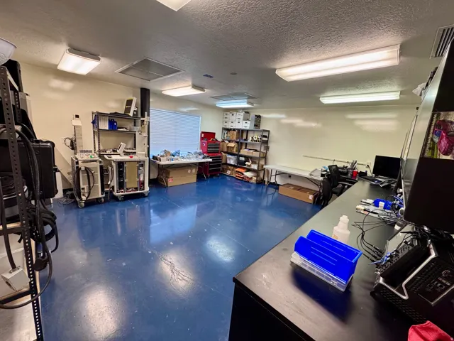 Unit a Cleanroom- Polished blue flooring, white painted walls, and ceiling-mounted fluorescent lighting