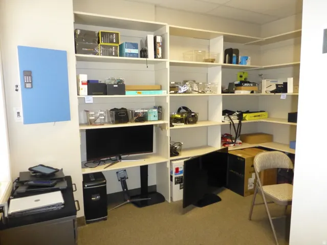 Unit D-Built-in shelving with integrated desk space and carpet flooring