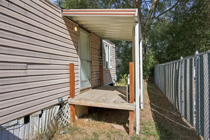 Covered porch entry featuring wood decking