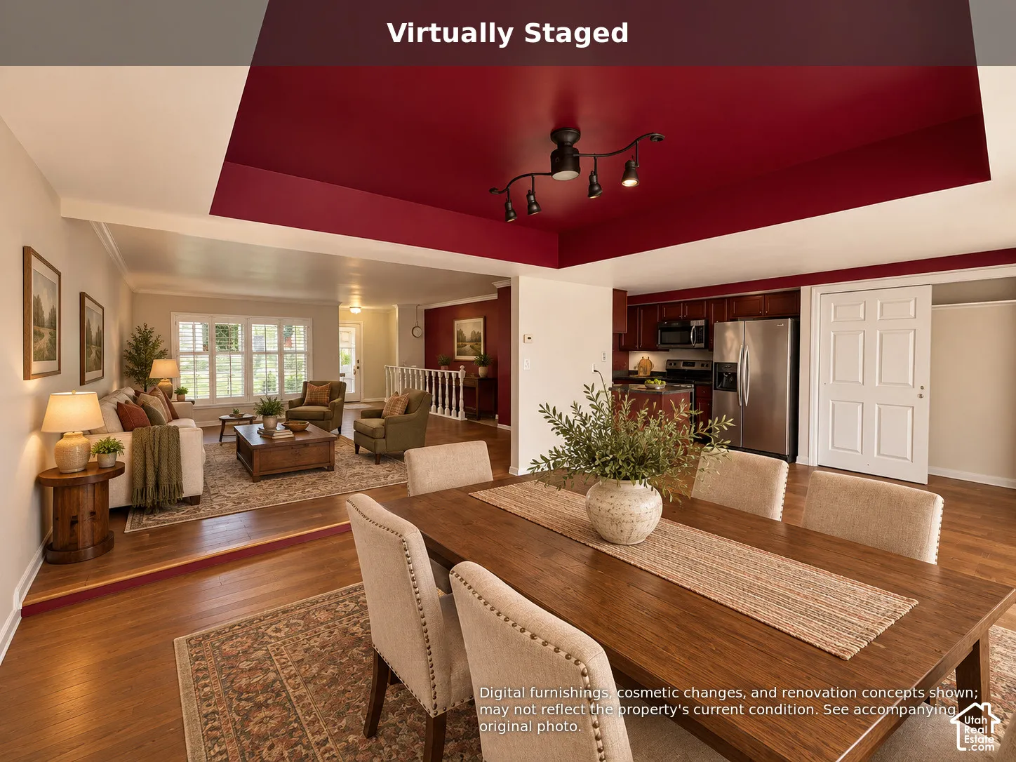 Open-concept interior featuring wood-finish flooring, a recessed tray ceiling, multi-directional track lighting, and a six-panel door
