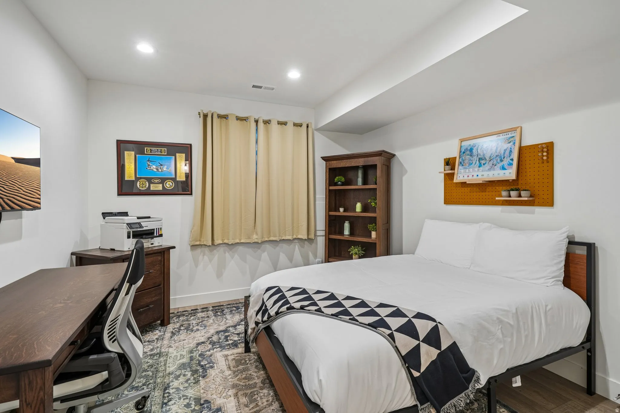 Recessed ceiling lighting, window with drapes, wood-finish flooring, and white walls