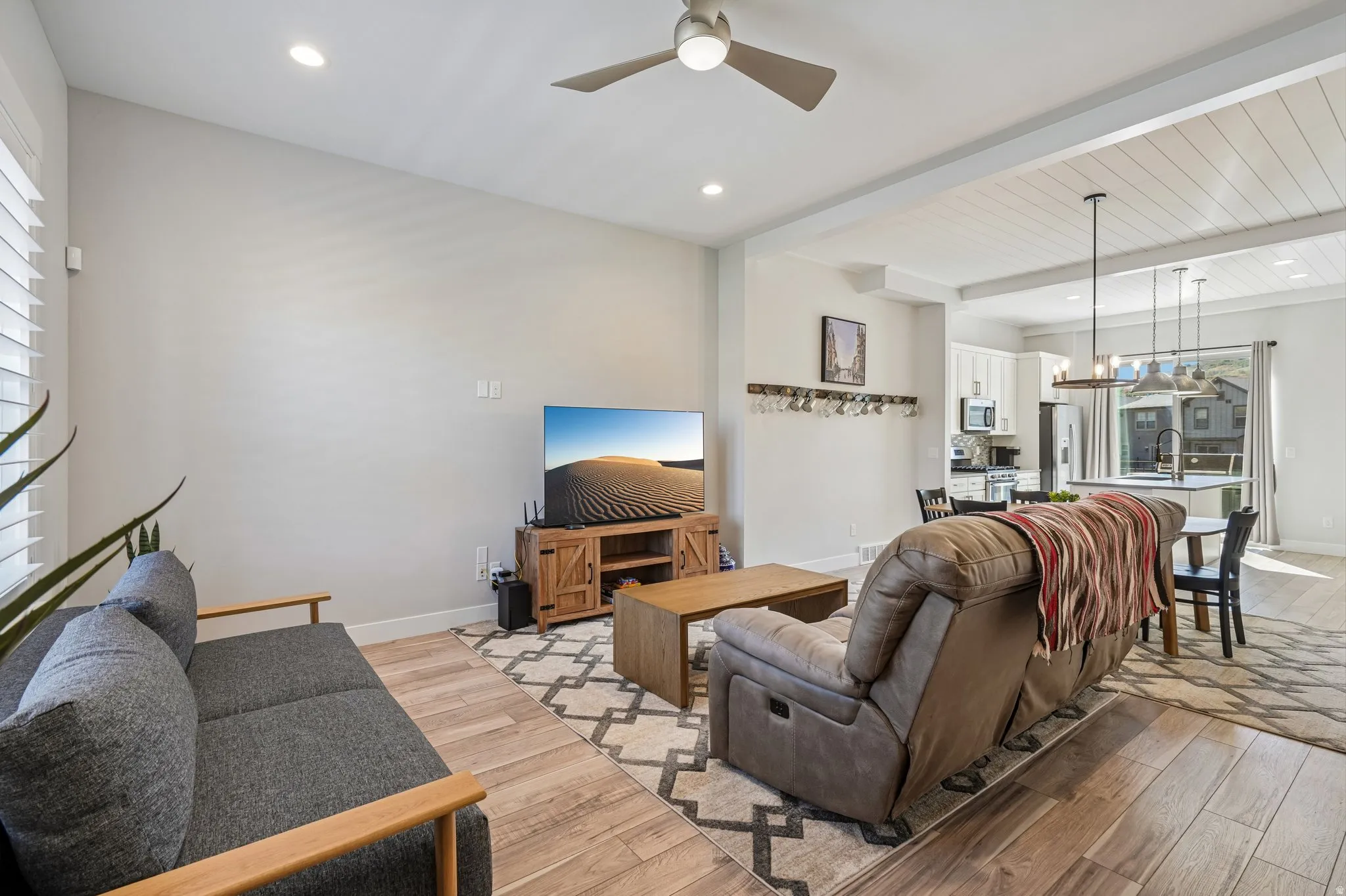 Wood-finish flooring, recessed lighting, and a ceiling fan
