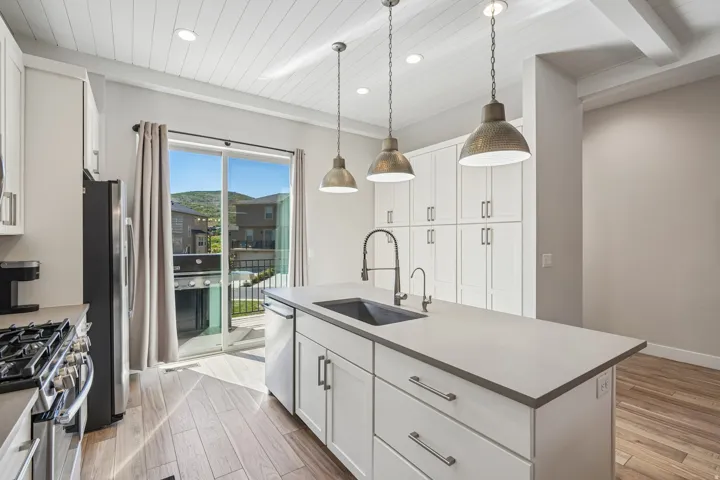 Kitchen featuring wood-finish flooring, white shaker cabinetry, recessed lighting, and a white plank ceiling