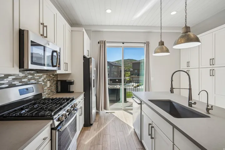 Kitchen featuring a gas range, built-in microwave, and stainless steel appliances