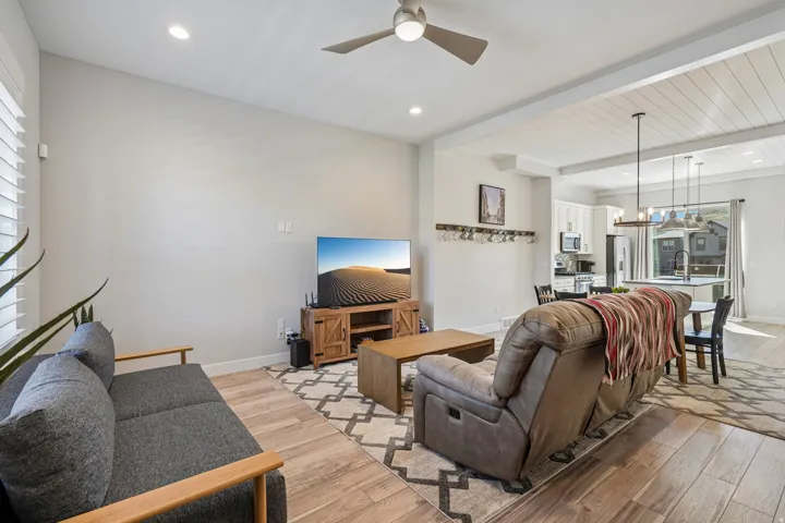 Wood-finish flooring, recessed lighting, and a ceiling fan