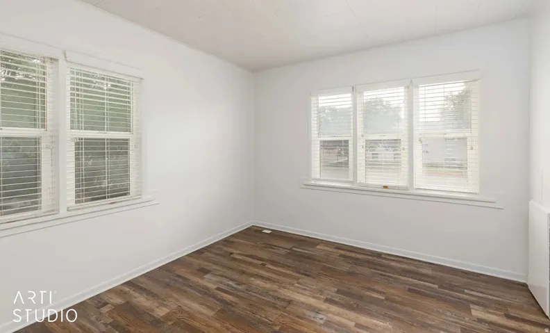 Wood-finish flooring with white walls and trim