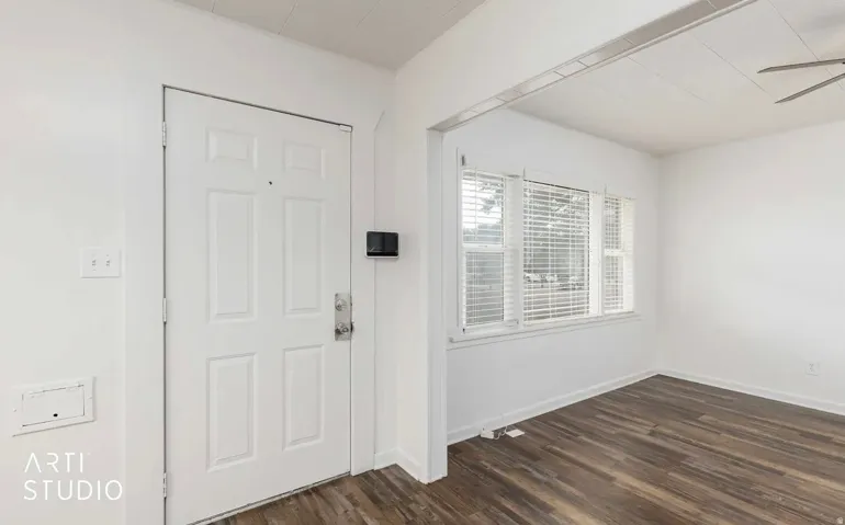 Clean white walls, wood-finish flooring, and white trim