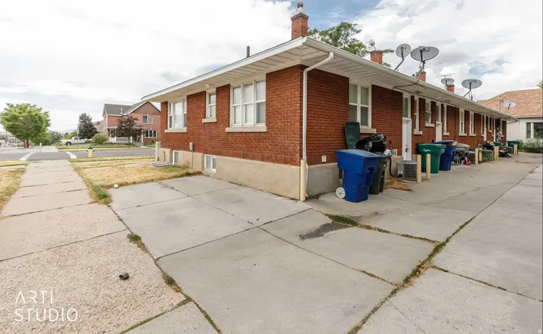 Brick exterior with multiple windows and concrete pathways